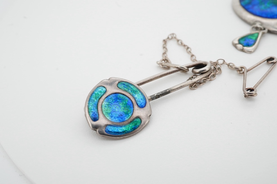 Charles Horner, an Arts and Crafts silver and enamel pendant and pin, early 20th century, the pendant of abstract design, applied with blue and green enamel, suspending a smaller drop, length 4.3cm, stamped CH for Charle